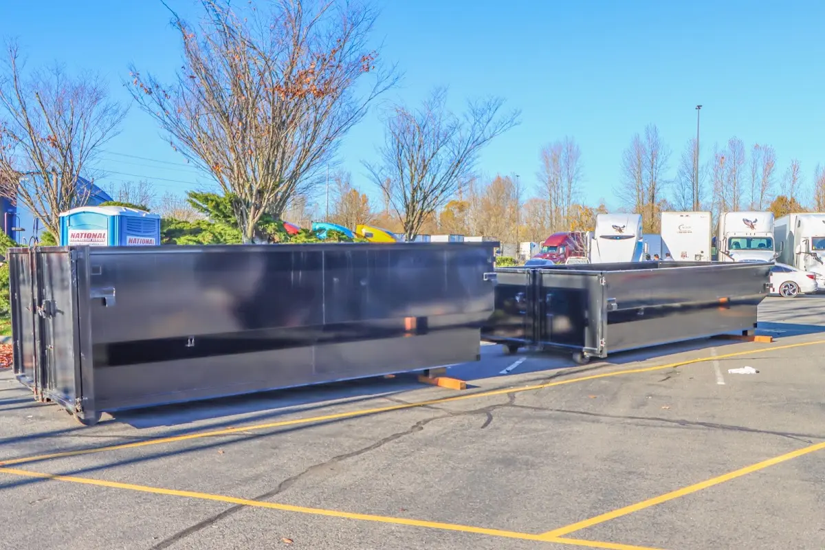 Professional dumpster rental service with roll-off container on residential driveway in Scotia